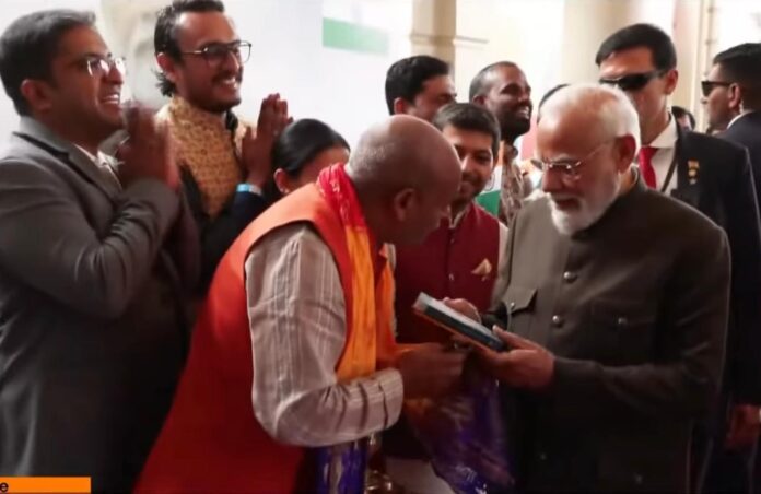 F-Mahaprasad-Govinda-Dasa-presents-the-newly-published-Amharic-Sri-Isopanisad-to-Indian-Prime-Minister-Narendra-Modi-during-his-state-visit-to-Ethiopia_